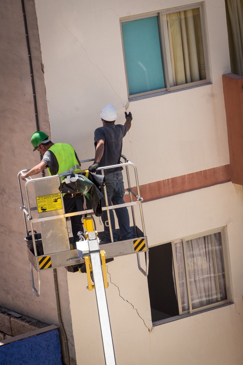 Obreros trabajan en las grietas surgidas o ampliadas a raíz del derrumbe en la parte del edificio aún en pie. ANDRÉS GUTIÉRREZ