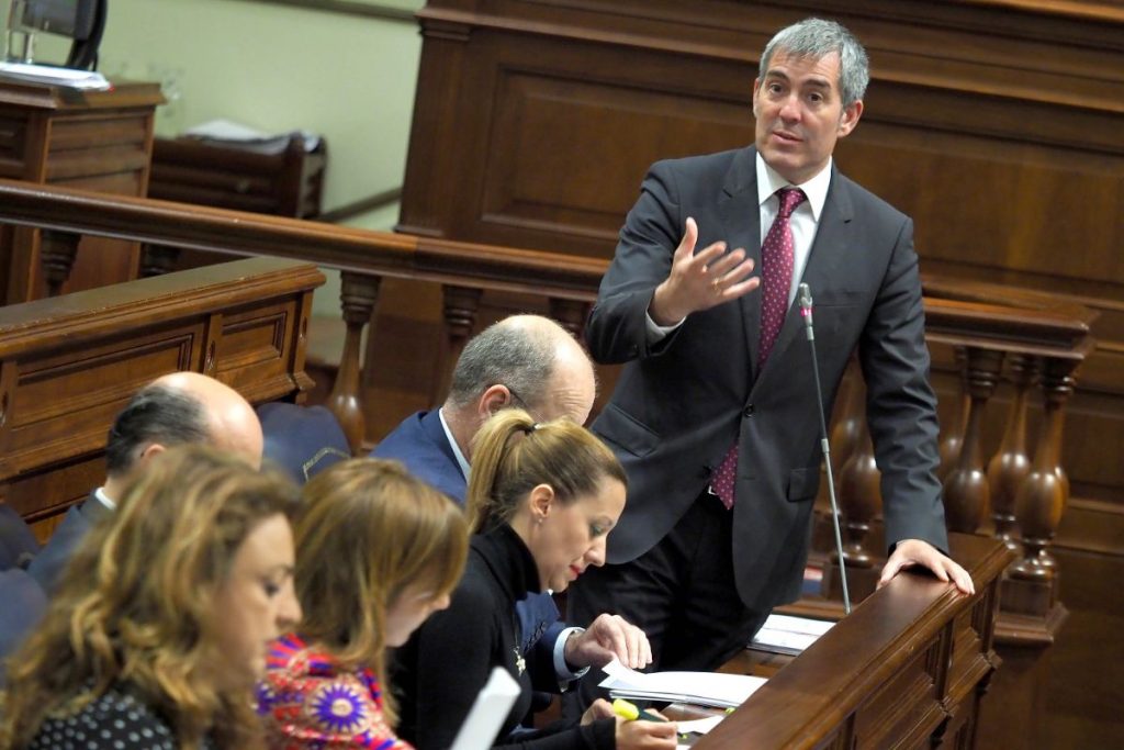 Clavijo, en la sesión de control. arriba a la izquierda, la portada del diario del 7 de abril que destapó el problema de la pobreza infantil en el Archipiélago. Sergio Méndez