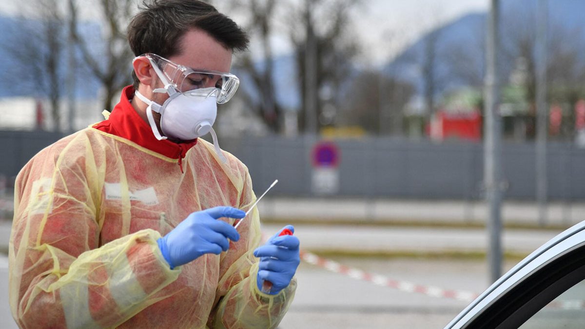 Un sanitario se dispone a tomar una muestra para un test de coronavirus. EFE